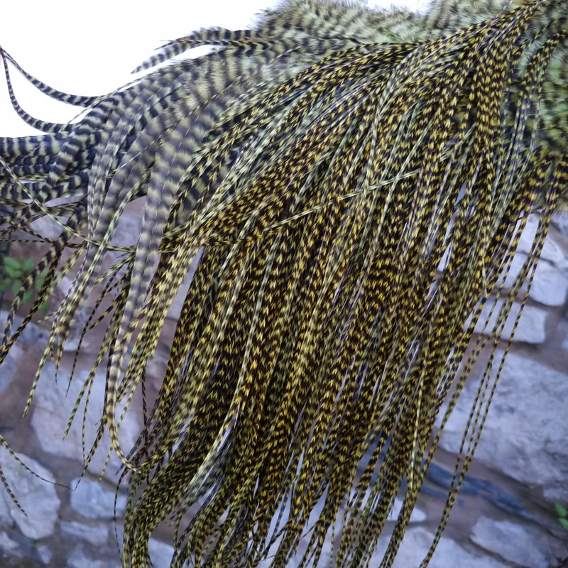 Whiting Pro-Grade Midge Rooster Saddle in Grizzly Dyed Olive B Approx tying size Stuffed with 14 16 you will find some 18 20 22 but you need to look for them.