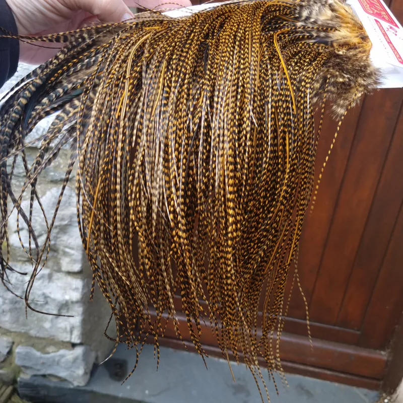 Whiting Pro-Grade Midge Rooster Saddle in Grizzly Dyed March Brown A Grizzly March Brown/ Lightly Splashed with Badger Dyed March Brown Approx Tying Sizes Few 14 and stuffed with 16/18/20/22 /24 and a few going smaller-10