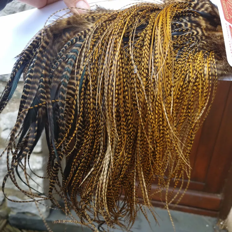 Whiting Pro-Grade Midge Rooster Saddle in Grizzly Dyed March Brown B Grizzly March Brown/Splashed with Badger March Brown Approx Tying Sizes  14 16 18 20 22 you might find a few smaller