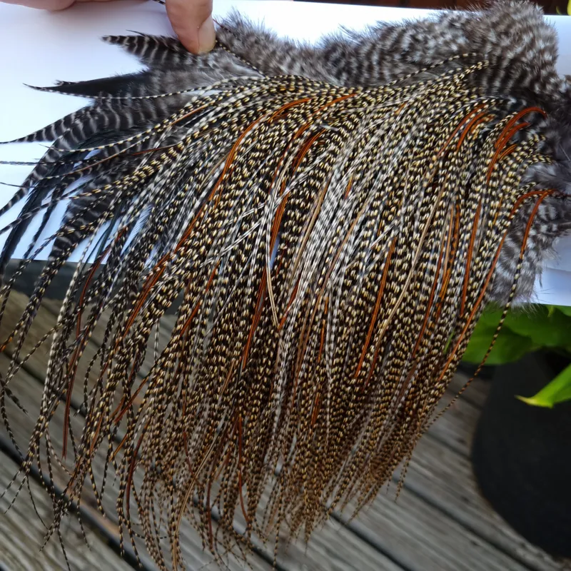 Whiting PRO-Grade Midge Rooster Saddle in CREE A Classic Cree Splashed with Furnace Approx tying size odd 14 and stuffed with 16/18/20-4