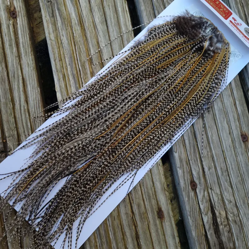 Whiting Pro-Grade Midge Rooster Saddle in Grizzly Variant C Classic Grizzly Lightly Splashed with Golden Badger Hackles Approx Tying Sizes  Few 14 stuffed with 16/18/20 and a few going smaller