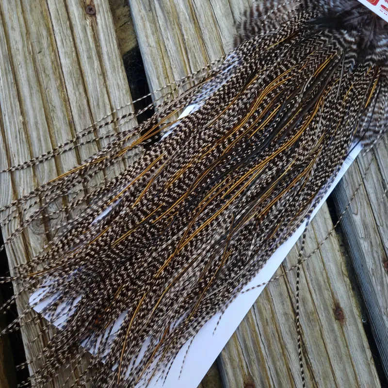 Whiting Pro-Grade Midge Rooster Saddle in Grizzly Variant E Dark Grizzly Splashed with Golden Badger Approx Tying Size 14/16/18
