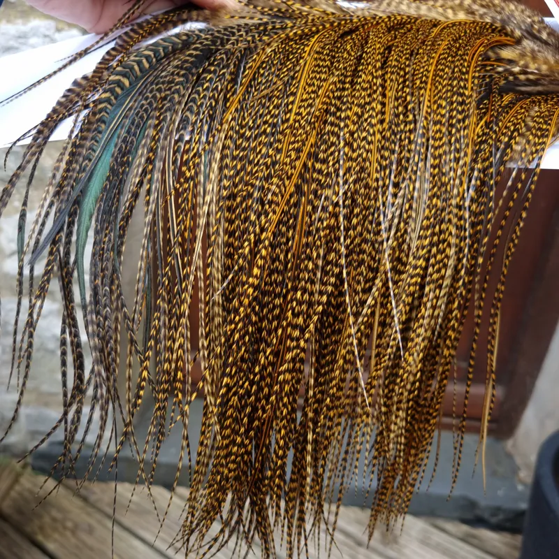 Whiting Pro-Grade Midge Rooster Saddle in Grizzly March Brown/ Splashed with Badger March Brown  A Approx Tying Sizes Some 14 and stuffed with 16/18/20/22 and you will find  a few going smaller